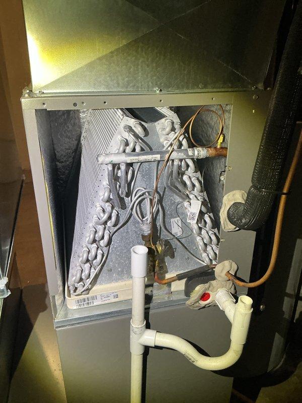 Completed annual cooling maintenance on residential split system. Performed comprehensive inspection of indoor air handler unit and outdoor condenser, including evaporator coil examination which showed clean condition with proper fin alignment, verification of refrigerant line connections and insulation integrity, and condensate drain line assessment. All components operating within normal parameters with no deficiencies noted.