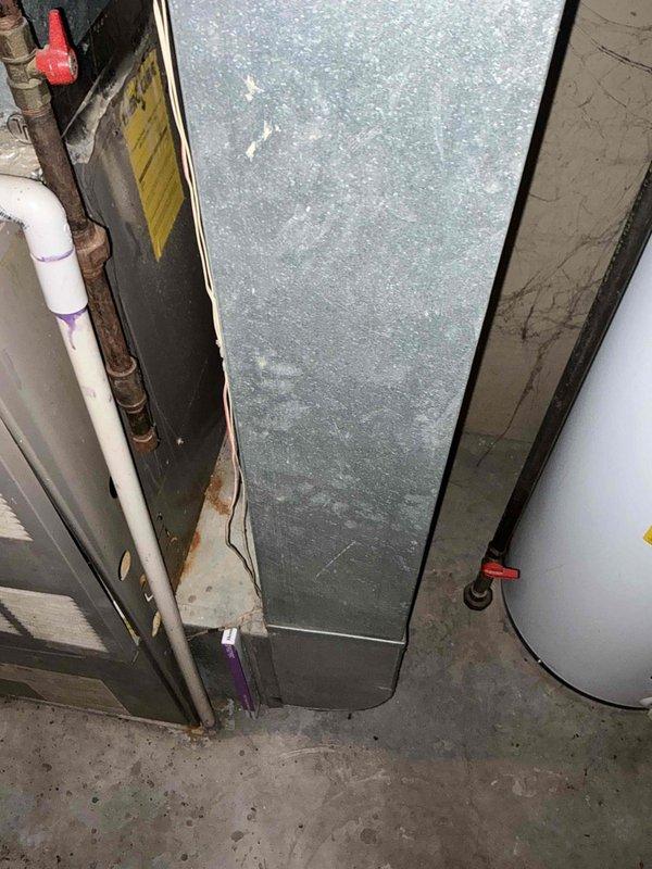 Completed comprehensive full system estimate for replacement of 16-year-old electric furnace and air conditioning system with dual-fuel propane capability. Performed thorough inspection and documentation of existing air handler unit located in basement utility space, evaluating current ductwork configuration, PVC condensate drainage lines, electrical connections, and copper refrigerant piping. Assessed condition of aging equipment showing visible wear, dust accumulation, and surface deterioration on metal cabinet housing. Photographed existing installation including air handler, associated ductwork, plumbing connections, and mechanical room layout to provide accurate equipment specifications and replacement recommendations for complete HVAC system upgrade.