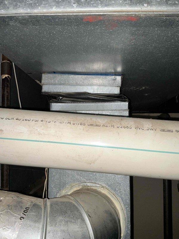Completed comprehensive full system estimate for replacement of 16-year-old electric furnace and air conditioning system with dual-fuel propane capability. Performed thorough inspection and documentation of existing air handler unit located in basement utility space, evaluating current ductwork configuration, PVC condensate drainage lines, electrical connections, and copper refrigerant piping. Assessed condition of aging equipment showing visible wear, dust accumulation, and surface deterioration on metal cabinet housing. Photographed existing installation including air handler, associated ductwork, plumbing connections, and mechanical room layout to provide accurate equipment specifications and replacement recommendations for complete HVAC system upgrade.