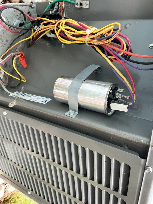Responded to a no-cooling complaint on a five-year-old residential air conditioning system affecting the entire home. Upon inspection of the outdoor condensing unit, identified a failed dual-run capacitor exhibiting significant rust and corrosion on the terminal end, preventing the compressor and condenser fan motor from operating. Removed the corroded capacitor, verified proper voltage at the contactor, and installed a new dual-run capacitor with correct microfarad ratings for both compressor and fan motor circuits. Tested system operation, confirmed compressor startup and condenser fan rotation, and verified proper amp draw on both circuits. System restored to normal cooling operation with appropriate temperature split across the evaporator coil.