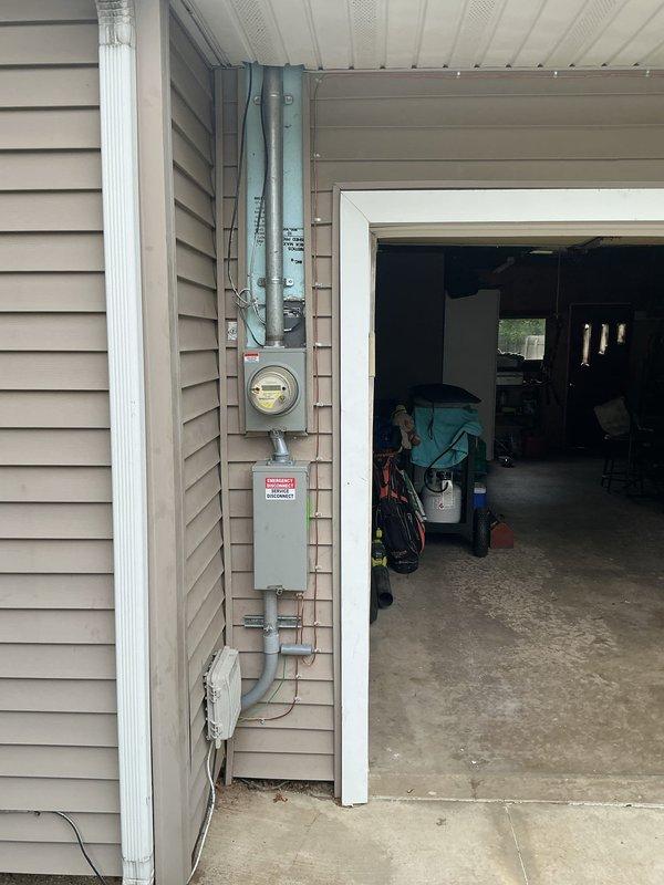 Returned to complete electrical service panel installation on residential exterior. Finalized meter base and panel box mounting on vinyl siding with proper conduit connections and weatherhead installation. Verified all components are properly secured, labeled, and ready for utility connection and final inspection.
