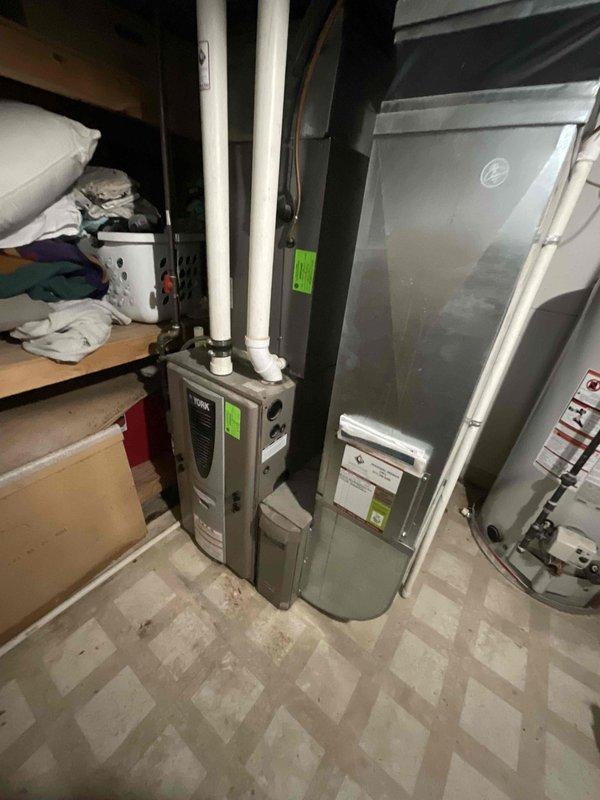 Conducted full system estimate for 16-year-old York HVAC system with confirmed refrigerant leak and complete cooling failure. Evaluated existing air conditioning unit, evaporator coil, and air handler in basement mechanical room to provide comprehensive replacement quote. Documented equipment condition and captured photographic evidence of current system configuration for replacement specifications.