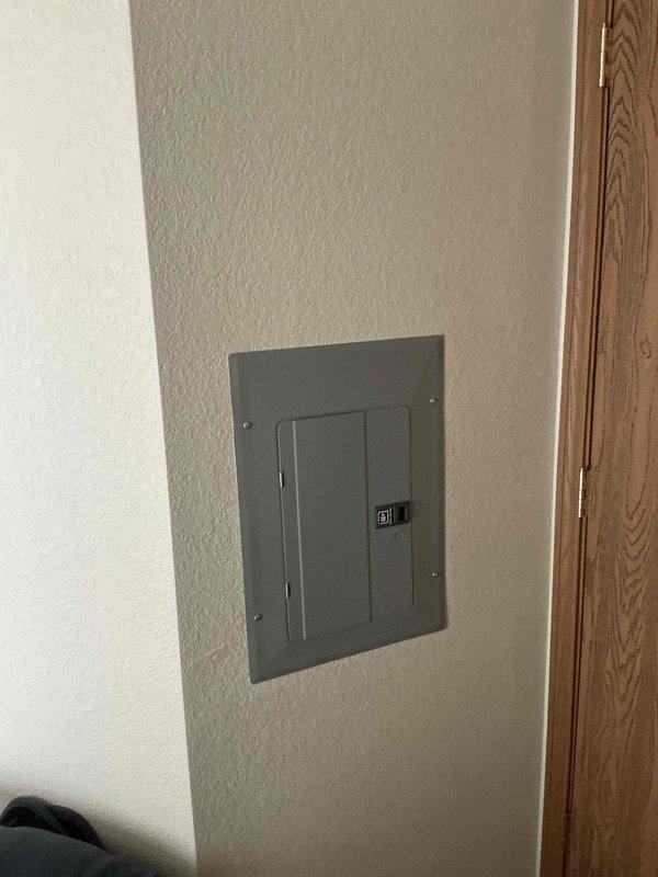 Provided estimate for replacement of Magic Pack HVAC system serving unit 201. Current equipment, installed in 2003, has a hole in the A/C component and requires full replacement. The natural gas furnace and air conditioning unit are located in an interior closet within the unit, with ductwork transitioning through the ceiling plenum and electrical panel accessible nearby.
