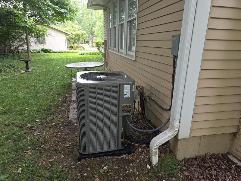 Successfully completed installation of 3.5-ton air conditioning system with matching evaporator coil at residential property. Outdoor condensing unit positioned on concrete pad against exterior wall with proper clearances, connected via refrigerant lines and electrical conduit routed through wall penetration. Indoor evaporator coil installed above existing Bryant furnace in basement utility area with PVC condensate drain lines properly configured. System startup performed with refrigerant line connections verified, electrical connections secured, and all components tested for proper operation. Permit requested for mechanical and air conditioning work prior to installation.