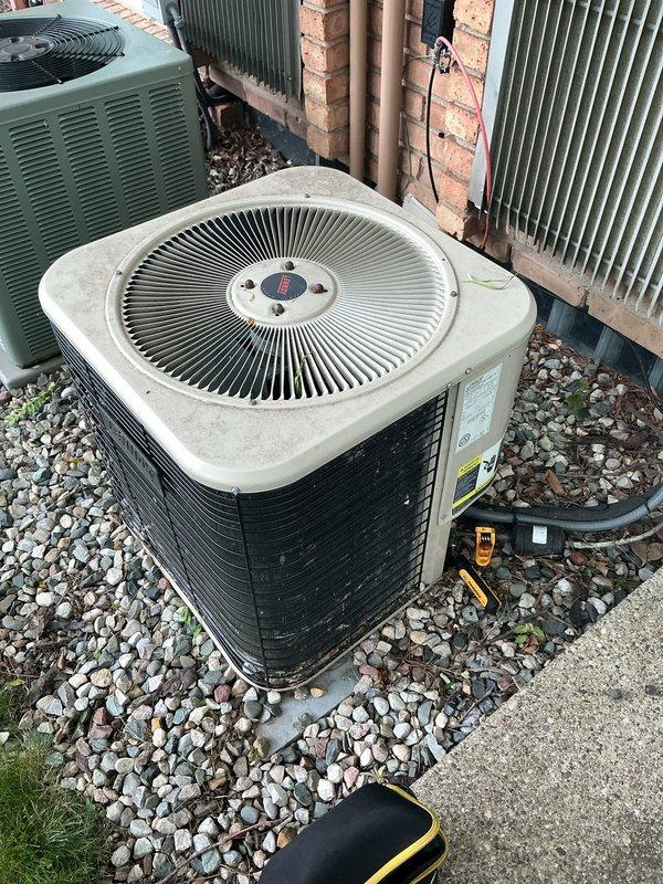 Completed comprehensive annual maintenance on 20-year-old residential central air conditioning system. Performed full system inspection of outdoor condenser unit, including visual assessment of heat exchanger coils which showed minor debris accumulation and light surface deposits on fins. Inspected refrigerant lines, electrical connections, and mechanical components for proper operation and wear. Cleaned condenser coils to remove accumulated dirt, leaves, and organic debris from fin surfaces to restore optimal heat transfer efficiency. Verified proper airflow through coil assembly and checked drainage around unit foundation. Tested system operation and confirmed all components functioning within normal parameters with no immediate service needs identified. Unit operating satisfactorily despite age, with routine maintenance completed to maintain system performance and reliability through upcoming cooling season.