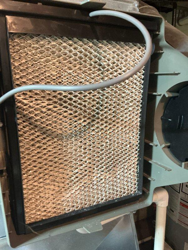 Completed annual heating check on HVAC system. Performed comprehensive inspection of evaporative cooler media, which showed normal dust and mineral accumulation consistent with regular operation. Inspected internal components including gas valve assembly, condensate collection system, electrical connections, and control boards. Verified all wiring connections were secure, checked refrigerant lines and insulation integrity, and confirmed proper mounting of all mechanical components. System operational and functioning within normal parameters.