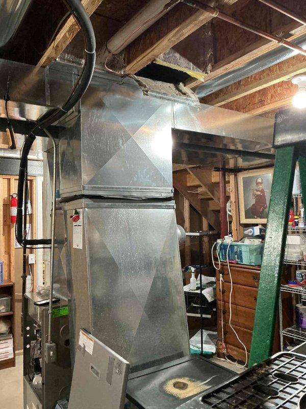Responded to service call for water leaking from ductwork on 19-year-old HVAC system located in basement. Upon inspection, identified condensate drainage issue causing water accumulation in ductwork. Cleared condensate line blockage, verified proper drainage flow, and confirmed system operation with no further leakage detected.