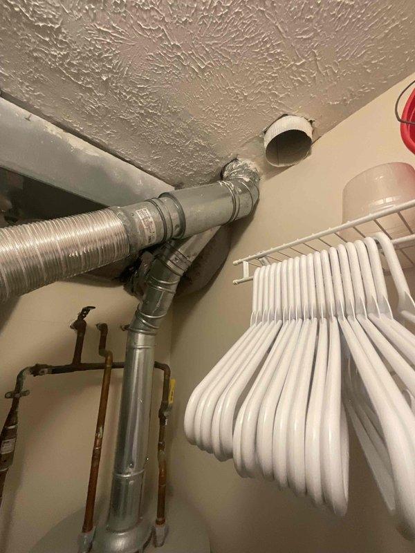 Provided estimate for water heater replacement in laundry room on main level, converting from existing gas tank water heater to electric tank model. Assessed current installation including gas venting system with aluminum duct and PVC exhaust piping, evaluated electrical panel capacity and available breaker positions for new electric water heater circuit requirements, and documented existing utility space configuration to determine equipment specifications and installation scope.