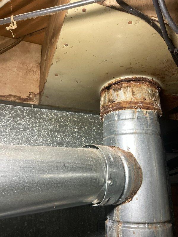 Responded to no-heat call on 10-year-old forced air furnace experiencing ignition failure. Upon inspection, found furnace initiating startup sequence but failing to complete ignition cycle. Diagnosed faulty pressure switch preventing gas valve from opening. Observed significant corrosion on exhaust vent piping and condensate drainage system, indicating moisture infiltration issues that contributed to pressure switch malfunction. Replaced defective pressure switch, cleared condensate drain line obstruction, and verified proper venting operation. Tested ignition sequence through multiple cycles, confirmed flame sensor operation, and validated system heating functionality. Recommended monitoring vent pipe corrosion and considering future vent system replacement to prevent recurring failures.