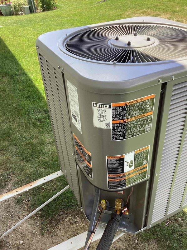 Completed installation of 2-ton air conditioning system with matching evaporator coil at residential property. Outdoor condensing unit positioned on concrete pad in backyard with proper refrigerant line connections and electrical hookup. Indoor evaporator coil integrated with existing Luxaire air handler, including new refrigerant piping, PVC condensate drain assembly with multiple trap configuration, and connection to existing Aprilaire humidifier system. All refrigerant lines insulated and secured, system tested for proper operation, and permits obtained for mechanical work only.