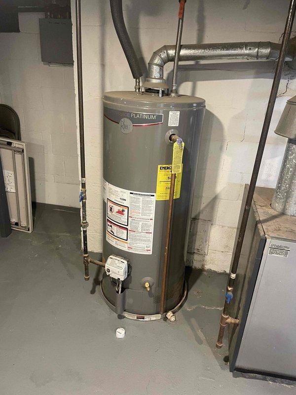 Conducted on-site assessment for new whole home generator installation at a trilevel residence. Evaluated existing electrical infrastructure including main service panel with adequate breaker capacity and documented utility room conditions in basement area with concrete block walls and sufficient clearance for equipment placement. Identified optimal generator location considering proximity to electrical panel, gas service access points, and required code-compliant clearances from building structures and existing mechanical equipment including water heater. Documented current electrical configuration to determine transfer switch requirements and load calculations for proper generator sizing to support whole home backup power needs.