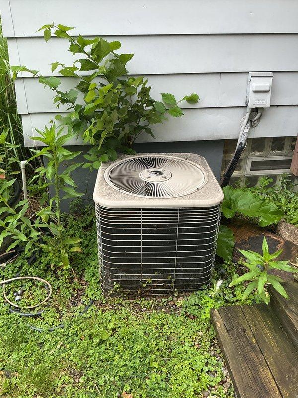 Responded to service call for air conditioning system experiencing intermittent operation with random starting and stopping. Upon arrival, inspected Lennox model HS29-024-1P condenser unit located in exterior landscaped area. Unit showed significant age with weathered exterior, dirt accumulation, and environmental exposure consistent with reported very old equipment age. Performed diagnostic evaluation of outdoor condenser unit to identify cause of intermittent cycling issue. Documented unit condition with photographs showing exterior wear, manufacturer specifications, and installation location against home foundation with electrical disconnect box. System assessed for electrical connections, component operation, and potential failure points causing erratic performance.