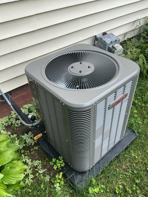 Completed annual cooling maintenance on residential HVAC system. Inspected outdoor condenser unit with cylindrical top grille and vertical louvered panels, verified proper operation of all components, checked refrigerant lines and electrical connections at disconnect box. Unit operating within normal parameters with no deficiencies noted.