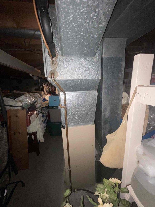 Provided comprehensive estimate for complete HVAC system replacement including air conditioning unit, furnace, and water heater in basement location. Current 30-year-old air conditioning system is non-operational while existing furnace remains functional. Assessed existing galvanized sheet metal ductwork system running vertically and horizontally throughout basement utility area, evaluated copper refrigerant lines, and documented current equipment configuration and installation conditions for replacement specifications.
