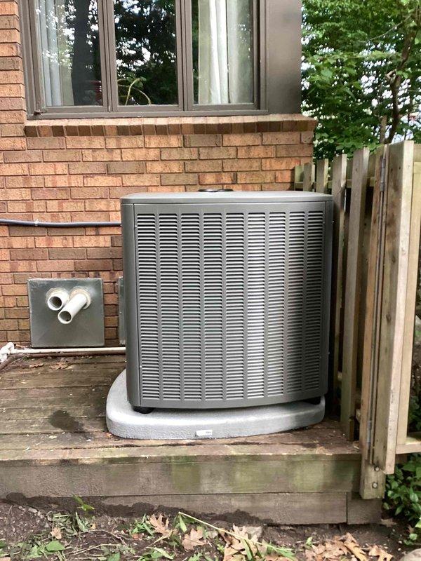 Completed full installation of 5-ton air conditioning system with matching evaporator coil at residential property. Positioned outdoor condenser unit on deck with proper condensate pan and installed electrical disconnect box with PVC conduit connections. Installed indoor air handler with evaporator coil in basement utility area, suspended horizontally with proper ductwork integration and support strapping. Reconnected all electrical connections, established refrigerant lines between indoor and outdoor units, and verified proper airflow through existing ductwork system. All work performed in accordance with mechanical permit requirements for left-side configuration installation.