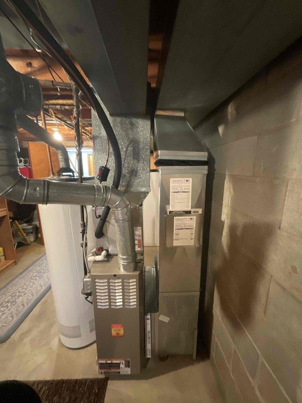Conducted residential estimate for complete HVAC system replacement including 20-year-old furnace and 9-year-old air conditioning unit. Inspected existing equipment in basement utility area, documented current system configuration with furnace and air handler positioned side-by-side with metallic ductwork connections. Provided replacement options and discussed available promotional offerings for simultaneous furnace and AC installation.