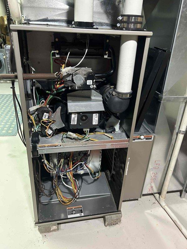 Responded to no-cool complaint on residential air conditioning system. Upon arrival, performed complete system diagnostic including inspection of both indoor furnace/air handler unit and outdoor condenser unit. Verified electrical power supply at disconnect box, checked thermostat operation and settings, and inspected all accessible components for obvious failures or damage. Examined indoor unit blower assembly, control boards, wiring harnesses, and condensate drainage system - all appeared functional with no visible signs of failure or deterioration. Proceeded to outdoor condenser unit where inspected compressor, fan motor, capacitor connections, and refrigerant line sets. Noted vegetation growth around condenser base affecting clearance requirements. Both units showed no obvious mechanical failures, damaged components, or electrical issues during visual inspection. System appeared to be properly maintained with components in serviceable condition. Documented equipment condition with 