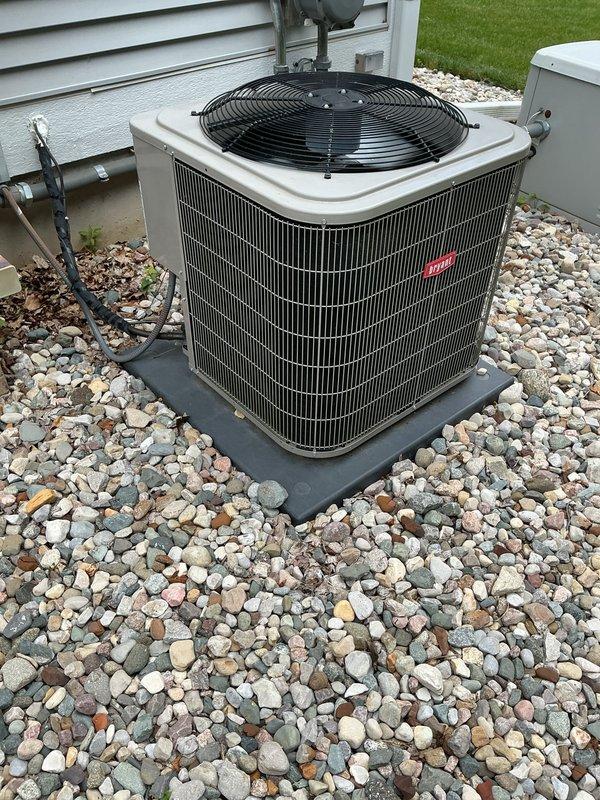 Completed annual cooling maintenance on residential air conditioning system. Performed comprehensive inspection of outdoor condensing unit, verified proper operation of condenser fan and compressor, checked refrigerant line insulation integrity, and confirmed unit was level on concrete pad with adequate clearance. Removed minor debris from surrounding area, inspected electrical connections, and documented equipment condition with photographs showing unit in good operating condition with clean coils and proper installation.