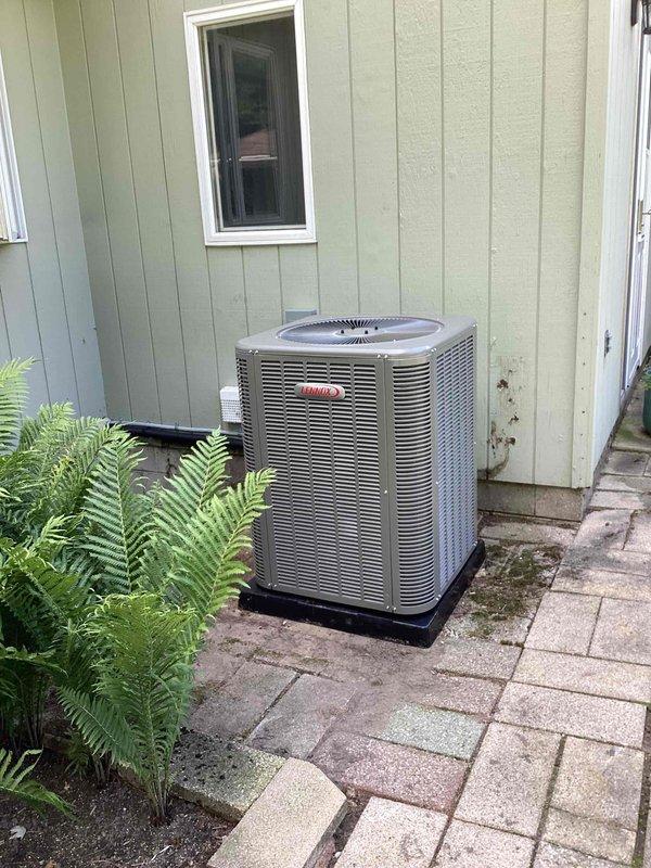 Completed full HVAC system installation including a 90,000 BTU furnace with humidifier and 3.5-ton air conditioning unit with rear discharge configuration. All equipment was installed per manufacturer specifications, with PVC venting routed through basement ceiling joists and condensate drainage properly configured. The Lennox condenser was positioned on a protective pad with paver stone base against exterior wall, with all refrigerant lines connected and electrical reconnection completed. Mechanical permit was obtained prior to installation, and all work was performed in compliance with local building codes and industry standards.