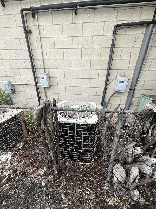 Provided estimate for replacement of 20-year-old ground-level air conditioning unit located on side of building. Current unit is non-operational with significant debris accumulation and deteriorated protective components. Customer has natural gas furnace and previously purchased AC system that failed shortly after installation.