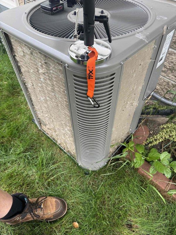 Completed comprehensive annual maintenance on 8-year-old forced air furnace and air conditioning system. Performed full AC tune-up on outdoor condenser unit, including inspection of fan motor assembly, cleaning of condenser coils, verification of refrigerant levels, and assessment of electrical connections. Inspected furnace components to ensure proper operation heading into heating season. Both units found to be functioning within normal parameters with no immediate service needs identified. Applied safety lockout tag during maintenance procedures. Cleared debris and vegetation from around condenser unit base to ensure adequate airflow. Documented equipment condition with photographic records showing unit exterior, fan assembly, and installation location. All maintenance tasks completed per ComfortGuard Maintenance Package specifications with systems returned to operational status.