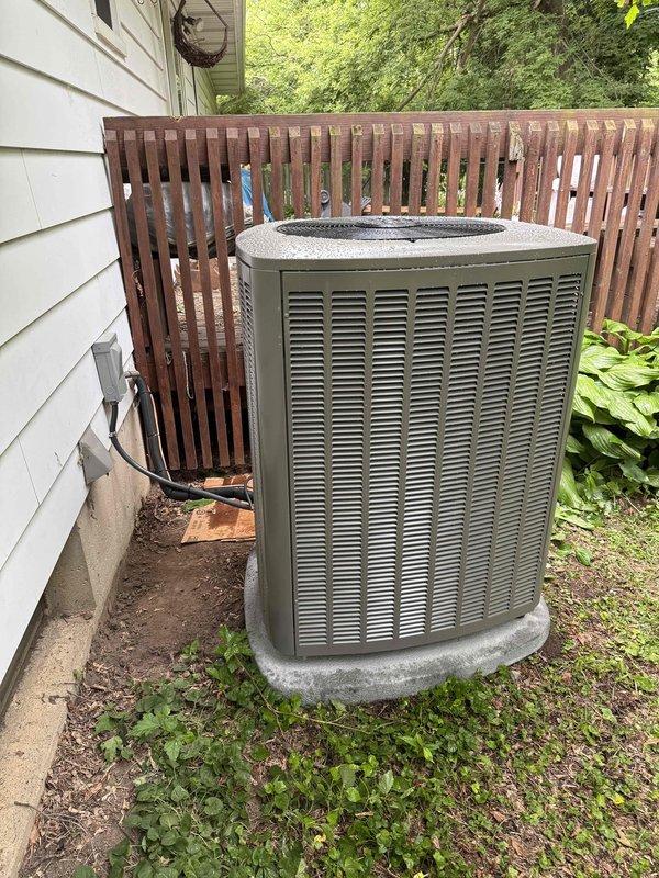 Completed full HVAC system installation including a 70,000 BTU furnace installed in basement utility area, 2-ton air conditioning condenser unit positioned on concrete pad at rear of residence, hot water heater replacement, and whole-home humidifier integration. All refrigerant lines and electrical conduit properly routed and connected, with ductwork secured to furnace plenum. System tested and operational upon completion, with all necessary permits obtained prior to installation.