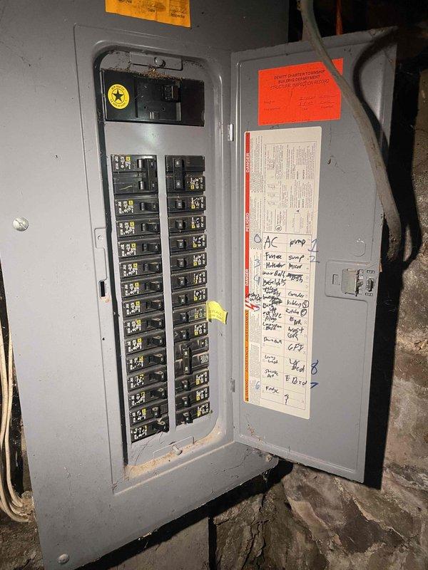 Provided comprehensive equipment replacement estimate for non-operational air conditioning system serving 2,000 square foot two-story residence with natural gas furnace. Existing AC unit located at side of house has exceeded 10+ years of service life and requires full replacement. Assessed electrical panel configuration and breaker capacity to ensure compatibility with new equipment specifications, documented existing Square D breaker panel with properly labeled circuits including dedicated AC disconnect.