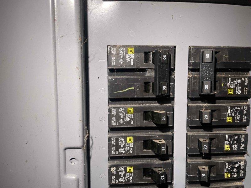 Provided comprehensive equipment replacement estimate for non-operational air conditioning system serving 2,000 square foot two-story residence with natural gas furnace. Existing AC unit located at side of house has exceeded 10+ years of service life and requires full replacement. Assessed electrical panel configuration and breaker capacity to ensure compatibility with new equipment specifications, documented existing Square D breaker panel with properly labeled circuits including dedicated AC disconnect.