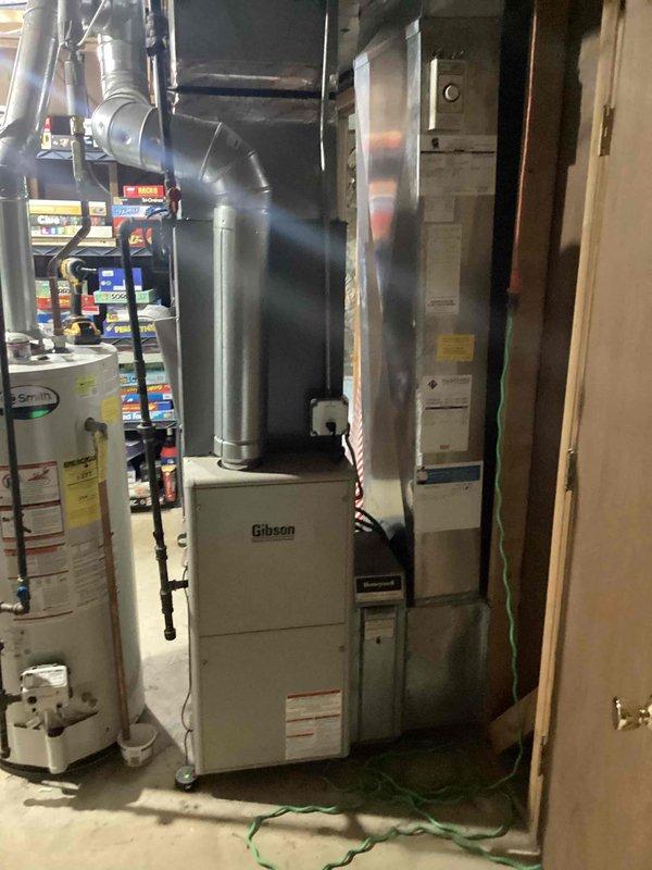 Successfully completed installation of a 2.5 ton air conditioning system with evaporator coil in basement mechanical room. Installed new AC condenser unit with rear discharge configuration, mounted new evaporator coil to existing Gibson furnace, and reconnected all refrigerant lines, electrical connections, and condensate drainage. All mechanical and electrical permits were obtained prior to installation, system was tested and verified operational upon completion.