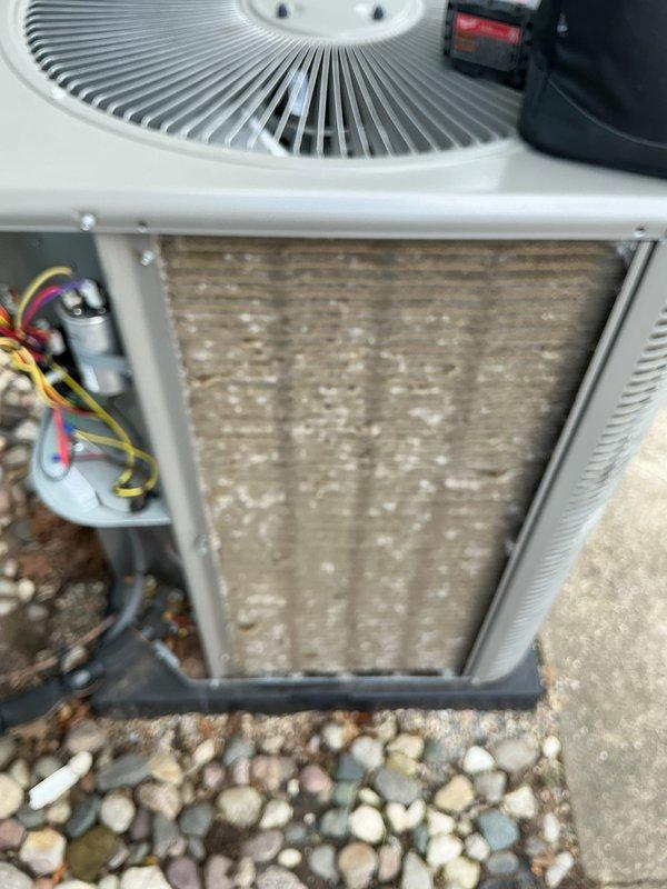 Completed annual cooling maintenance on residential air conditioning system. Performed comprehensive inspection of outdoor condenser unit, noting heavily soiled condenser coil requiring cleaning attention. Accessed electrical compartment to inspect capacitor, contactor, and wiring connections. Documented equipment condition through photographic documentation showing significant dirt and debris accumulation on coil surfaces that could impact system efficiency and airflow if not addressed during future service intervals.