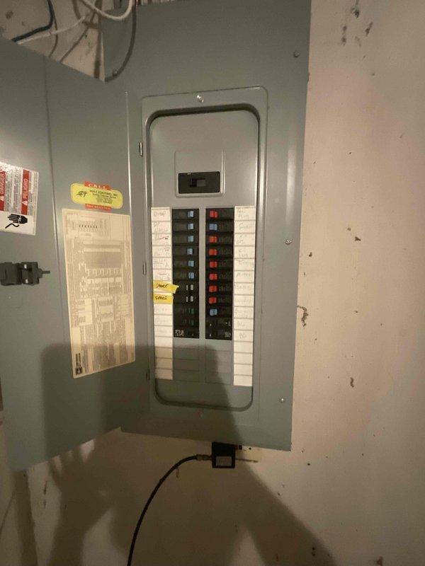 Assessed existing 30-year-old forced air heating and cooling system for complete replacement. Furnace was non-operational, leaving residence without heat. Evaluated electrical panel, indoor furnace installation area accessible through garage, and outdoor condenser unit positioned against home exterior with significant vegetation overgrowth requiring consideration for equipment access and service clearance during replacement installation.