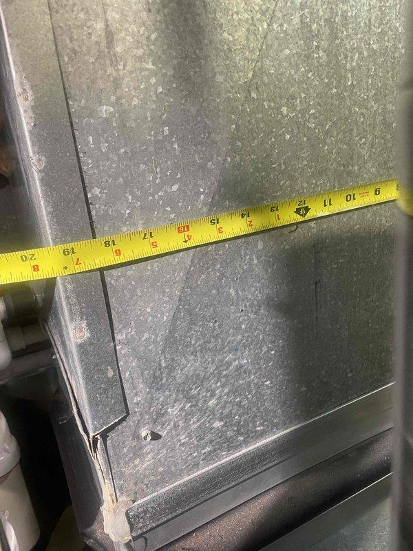 Responded to service call for non-functional central air conditioning system where only the blower fan was operational. Upon inspection, discovered severe frost and ice accumulation on the evaporator coil, indicating a refrigerant issue or restricted airflow causing the coil to freeze. Documented measurements and conditions of the affected equipment in the mechanical room, which included the air handler unit, associated ductwork, and connected HVAC components. Provided estimate for complete system replacement due to the extent of the malfunction and inability to provide adequate cooling.