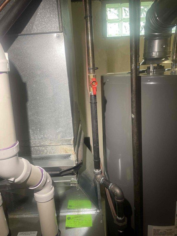 Responded to service call for non-functional central air conditioning system where only the blower fan was operational. Upon inspection, discovered severe frost and ice accumulation on the evaporator coil, indicating a refrigerant issue or restricted airflow causing the coil to freeze. Documented measurements and conditions of the affected equipment in the mechanical room, which included the air handler unit, associated ductwork, and connected HVAC components. Provided estimate for complete system replacement due to the extent of the malfunction and inability to provide adequate cooling.