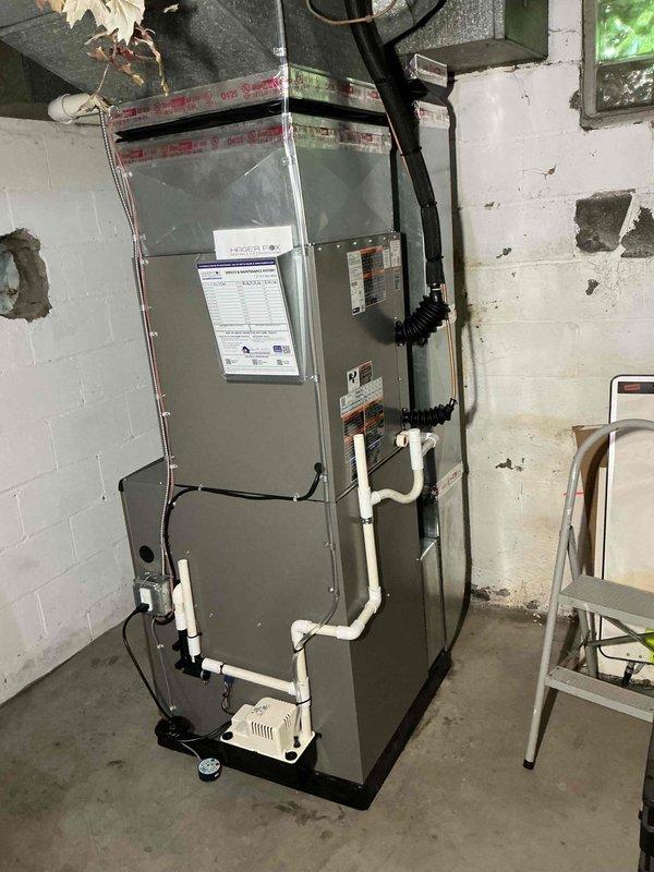 Completed full HVAC system installation in basement utility room, including 90,000 BTU high-efficiency furnace with PVC venting system, 3-ton air conditioning condenser unit positioned at rear of property, and required electrical circuit installation per NEC standards. All mechanical and electrical permits were obtained prior to installation, and system was installed against concrete block wall with proper condensate drainage, electrical conduit routing, and ductwork connections completed to manufacturer specifications.
