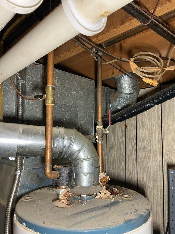 Responded to service call for leaking condensation pump on 5-year-old furnace system located in basement. Upon arrival, inspected HVAC equipment and associated plumbing components including water heater, ductwork, and drainage systems. Identified condensation pump failure as source of water leak. Documented equipment condition and surrounding infrastructure with photographs showing copper piping, galvanized ductwork, and utility connections. System is not covered under parts or labor warranty.