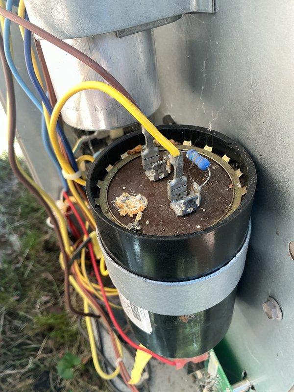 Responded to non-operational air conditioning system that had been inoperative for approximately one year. Upon diagnostic inspection of 1995 vintage equipment located in basement, identified failed control board as primary cause of system failure. Visual inspection revealed corroded capacitor terminals with white crystalline deposits and rust-colored deterioration on motor component, indicating electrical degradation. Control board displayed multiple wire connections across various terminals with visible wear on PCB components. Documented equipment condition through photographic evidence showing extent of component deterioration and recommended complete control board replacement to restore system functionality.