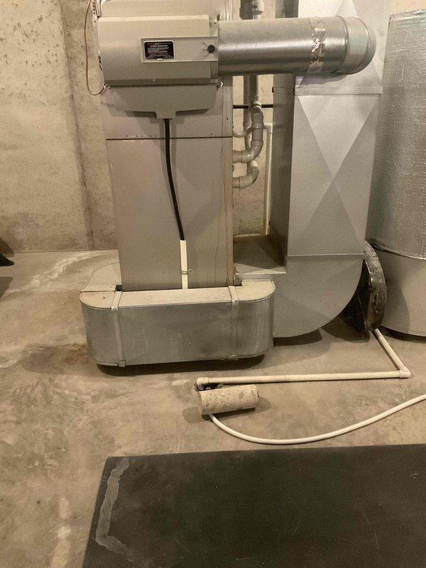 Provided replacement estimate for 20+ year old natural gas furnace located in basement and air conditioning unit positioned at side of house. Current furnace operational; air conditioning unit experiencing intermittent functionality issues. Assessed existing HVAC system configuration including basement mechanical room setup with water heater and filtration equipment, documented equipment specifications and installation requirements for complete furnace and AC replacement recommendation.