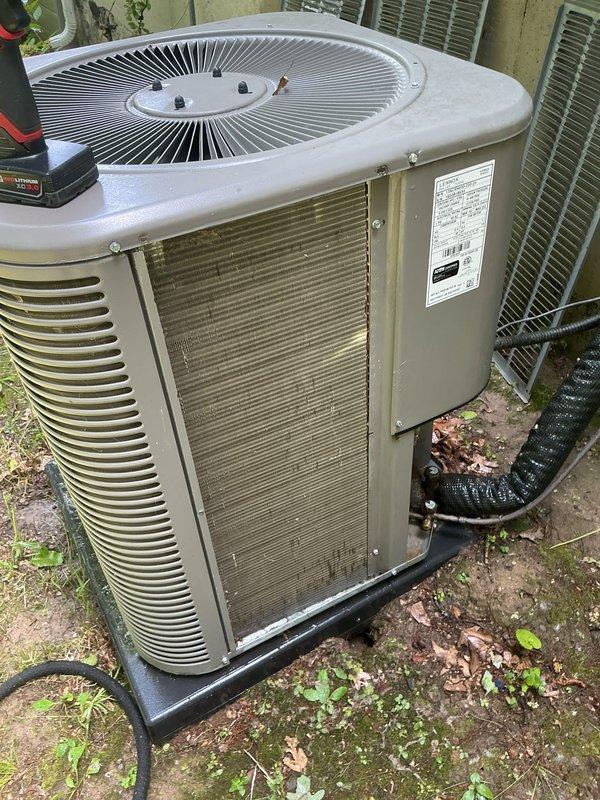 Completed annual cooling maintenance on outdoor condensing unit. Inspected and cleaned condenser coils which showed accumulation of dirt, debris, and environmental buildup on cooling fins and exterior surfaces. Checked refrigerant lines, electrical connections, and control board for proper operation. Verified fan motor operation and reset button functionality. Replaced air filter per maintenance protocol. Unit operating within normal parameters upon completion of service.
