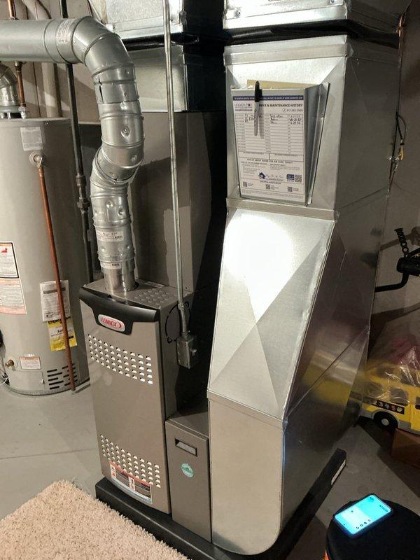 Completed annual cooling maintenance on Lennox HVAC system. Inspected evaporator coil assembly and refrigerant lines, verified heat exchanger fins are clean and in proper working condition, and documented system components including furnace unit and ductwork connections for maintenance records.