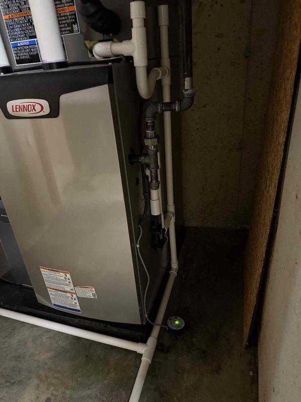 Completed full HVAC system installation including a 70,000 BTU Lennox furnace, 2.5-ton air conditioning unit with evaporator coil configured for rear discharge, and humidifier reconnection. All gas piping, PVC condensate drainage, and venting installed to code specifications with proper foundation penetrations and exterior terminations. System tested and operational upon completion with all permits obtained.
