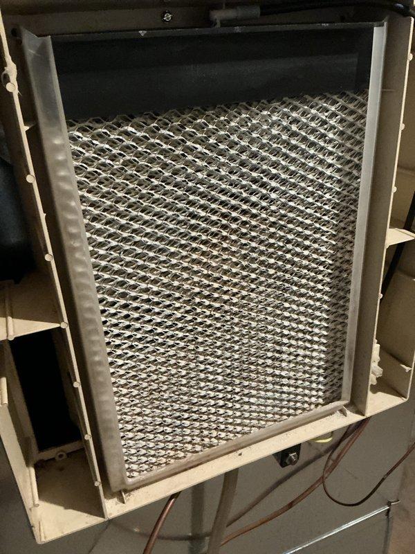 Performed comprehensive cooling system tune-up on residential HVAC unit. Inspected and evaluated air filtration system, noting accumulated dust and debris on pleated filters with diamond pattern mesh. Completed standard maintenance procedures including system performance verification, with all components operating within normal parameters and no deficiencies identified.
