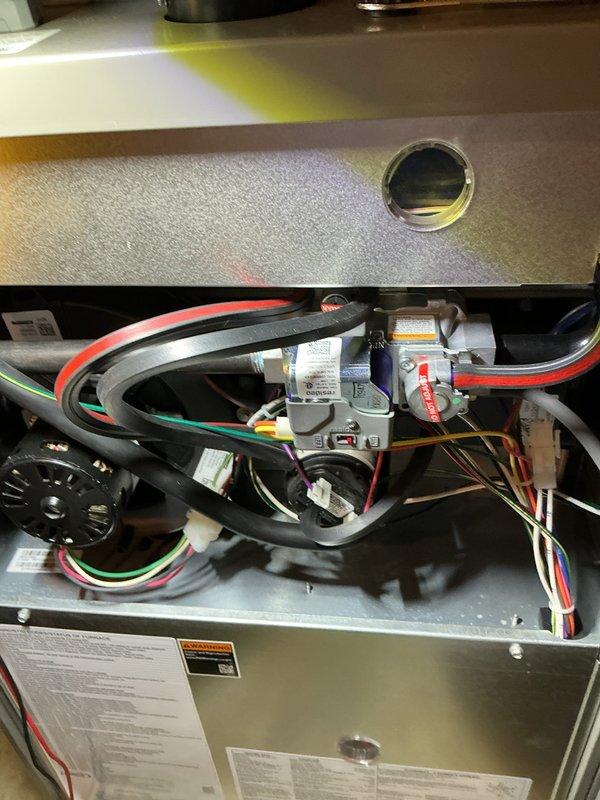 Completed comprehensive 5-year ComfortGuard maintenance visit on residential HVAC system. Performed thorough inspection of indoor furnace unit, examining gas valve assembly, electrical connections, blower motor housing, and all associated wiring for proper operation and safety compliance. Conducted exterior evaluation of Lennox condensing unit, verifying refrigerant line integrity, electrical conduit connections, and overall system performance. All components found operating within normal parameters with no deficiencies noted.