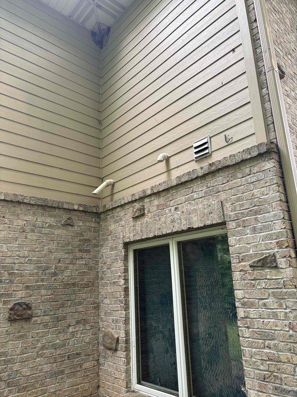 Completed full HVAC system installation including a 70,000 BTU furnace with left-side configuration, 2-ton air conditioning unit, evaporator coil, and humidifier reconnection. The outdoor condensing unit was mounted on a platform against the exterior brick wall with proper electrical conduit and refrigerant line installation. All necessary permits were obtained prior to installation, and the complete system was installed, tested, and left in proper working order.