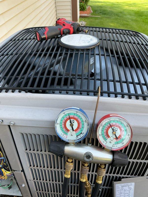 Completed annual HVAC maintenance on residential air conditioning unit. Performed system inspection, checked refrigerant pressures using manifold gauges, verified R-410A charge levels, and documented equipment specifications including model CNPVP3017ALAAAAA. Unit operating within normal parameters with all safety labels intact and legible.