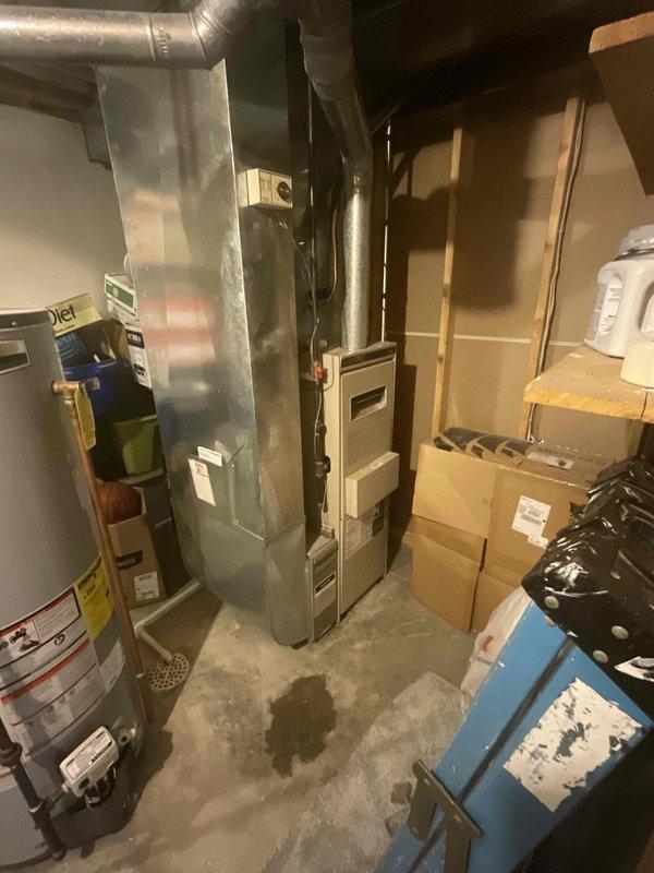 Conducted comprehensive site assessment for replacement estimate of 26-year-old furnace and air conditioning system in single-family residential property. Inspected existing gas furnace located in basement utility area and outdoor condensing unit, both operating at end of serviceable life expectancy. Evaluated current system configuration including ductwork connections, venting arrangements, electrical service, and clearance requirements for equipment replacement. Documented existing equipment specifications, physical dimensions, and installation conditions through photographic records. Assessed basement mechanical room layout with concrete flooring, existing water heater proximity, overhead duct routing, and structural support considerations. Verified adequate access for equipment removal and new installation. Reviewed electrical panel capacity and gas line configuration to determine compatibility with replacement equipment options. Customer seeking expedited replacement timeline with