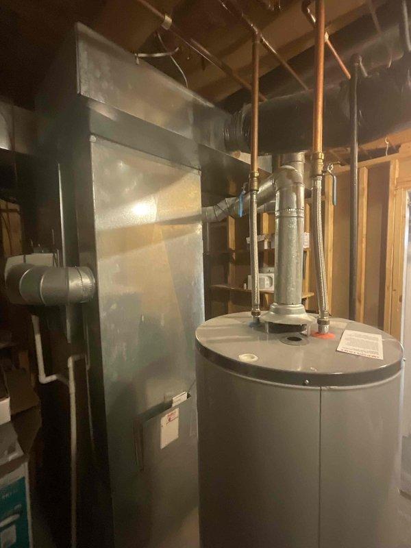 Conducted comprehensive site assessment for replacement estimate of 26-year-old furnace and air conditioning system in single-family residential property. Inspected existing gas furnace located in basement utility area and outdoor condensing unit, both operating at end of serviceable life expectancy. Evaluated current system configuration including ductwork connections, venting arrangements, electrical service, and clearance requirements for equipment replacement. Documented existing equipment specifications, physical dimensions, and installation conditions through photographic records. Assessed basement mechanical room layout with concrete flooring, existing water heater proximity, overhead duct routing, and structural support considerations. Verified adequate access for equipment removal and new installation. Reviewed electrical panel capacity and gas line configuration to determine compatibility with replacement equipment options. Customer seeking expedited replacement timeline with