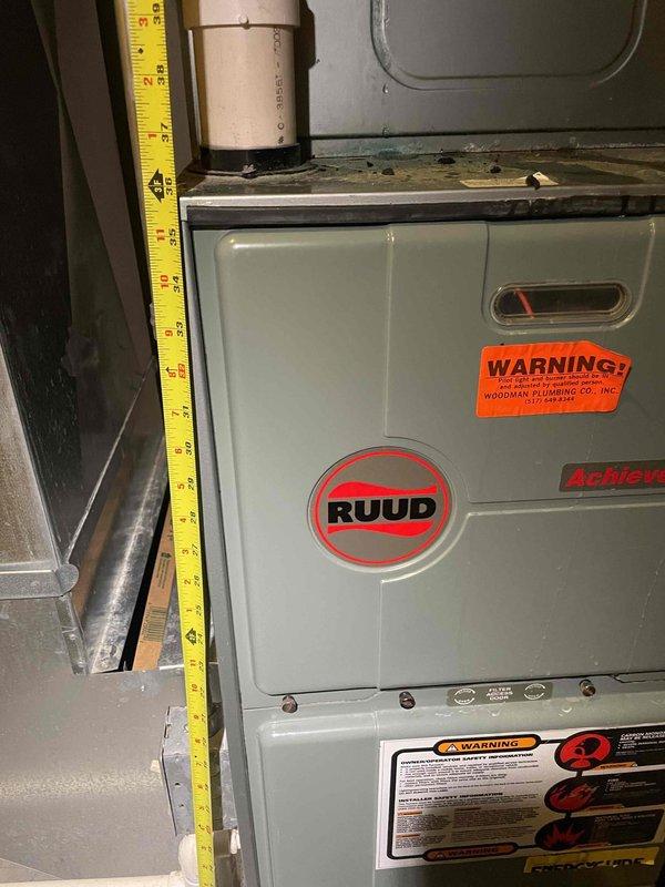 Conducted comprehensive assessment of existing forced air HVAC system for replacement estimate in single-family residence. Inspected 25-year-old outdoor air conditioning unit and Ruud Achiever furnace located in basement, documenting equipment dimensions, clearances, and current installation configuration. Measured spatial requirements around furnace unit and existing PVC venting system to determine replacement equipment specifications and installation feasibility. Photographed existing equipment, ductwork connections, and utility room layout to prepare detailed replacement proposal for complete heating and cooling system upgrade.