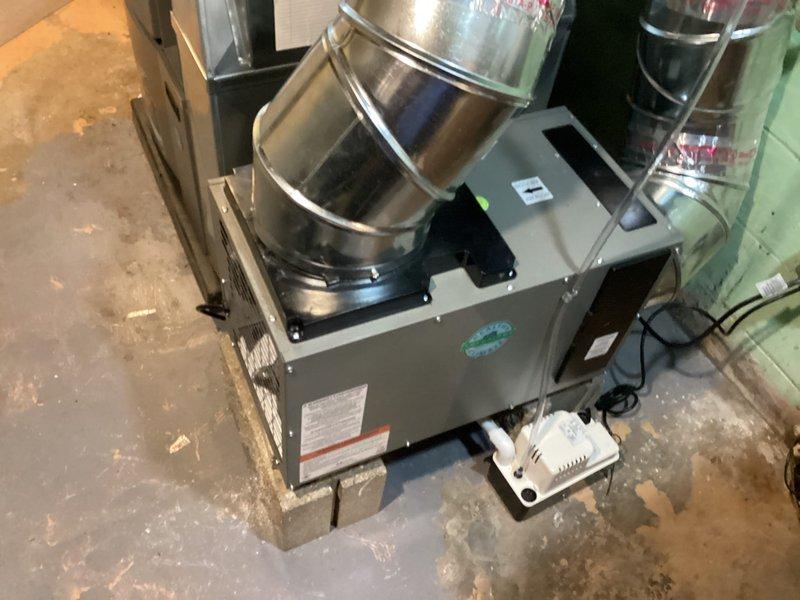 Successfully installed whole-home dehumidifier system in basement utility area, integrating unit with existing HVAC infrastructure. Connected dehumidifier to main air handler via metallic ductwork transitions, ensuring proper airflow distribution throughout the system. Completed all electrical connections, mounted control panel, secured ductwork with appropriate sealing, and verified operational functionality of the installed indoor air quality equipment.