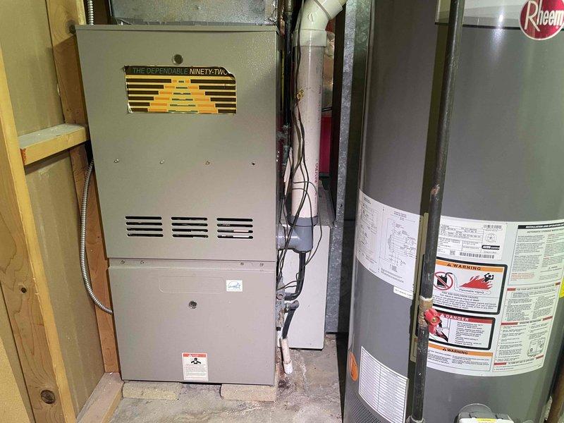 Conducted on-site evaluation of existing 20-year-old central air conditioning system for replacement estimate. Inspected outdoor condensing unit and indoor air handler components, documenting current equipment condition and installation configuration. Photographed existing HVAC infrastructure including furnace, ductwork connections, condensate drain lines, and mechanical room layout to assess replacement requirements and system compatibility. Provided comprehensive replacement estimate for new central air conditioning system with expedited installation timeline per request.