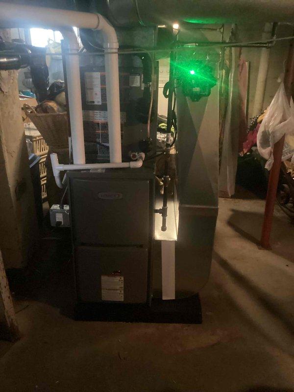 Completed full HVAC system installation in basement mechanical room, including Lennox 45,000 BTU furnace (Model CK40CT-24B-71) and 1.5 ton air conditioning unit with rear discharge configuration. Installed new furnace on rubber isolation mat with proper PVC venting routed through ceiling joists, established new dedicated electrical circuit to meet code requirements, and completed all mechanical and electrical permit work. System tested and operational upon completion.